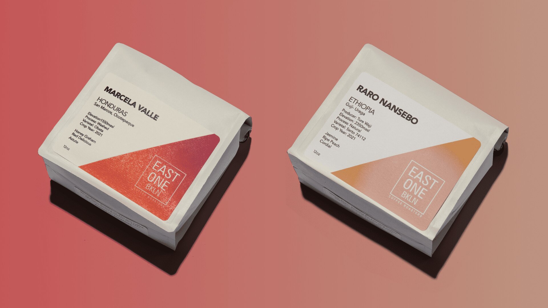 Two specialty coffee bags on coral background: Marcela Villegas Ethiopia single-origin on left with red accent, Raro Nansebo Ethiopia on right with tan accent, both branded with East One Coffee logo