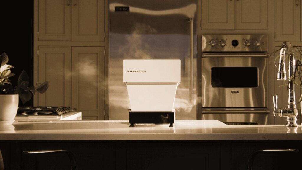 La Marzocco Linea Micra espresso machine in white with stainless steel refrigerator, modern kitchen countertop setup