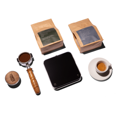 La Marzocco espresso machine, grinder, and coffee accessories flat lay with scale