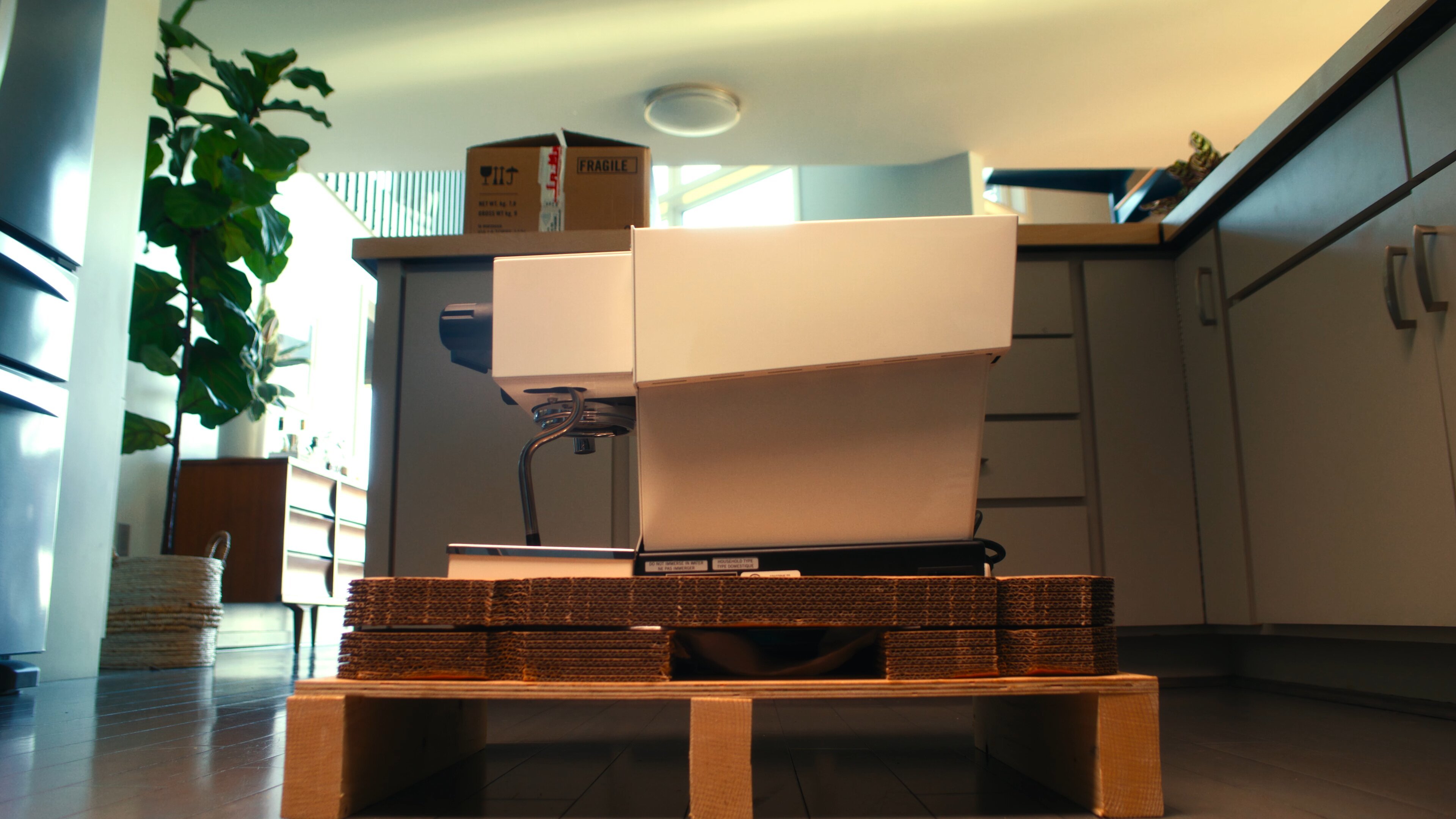 La Marzocco Linea Mini espresso machine unboxing in a modern home interior with delivery packaging