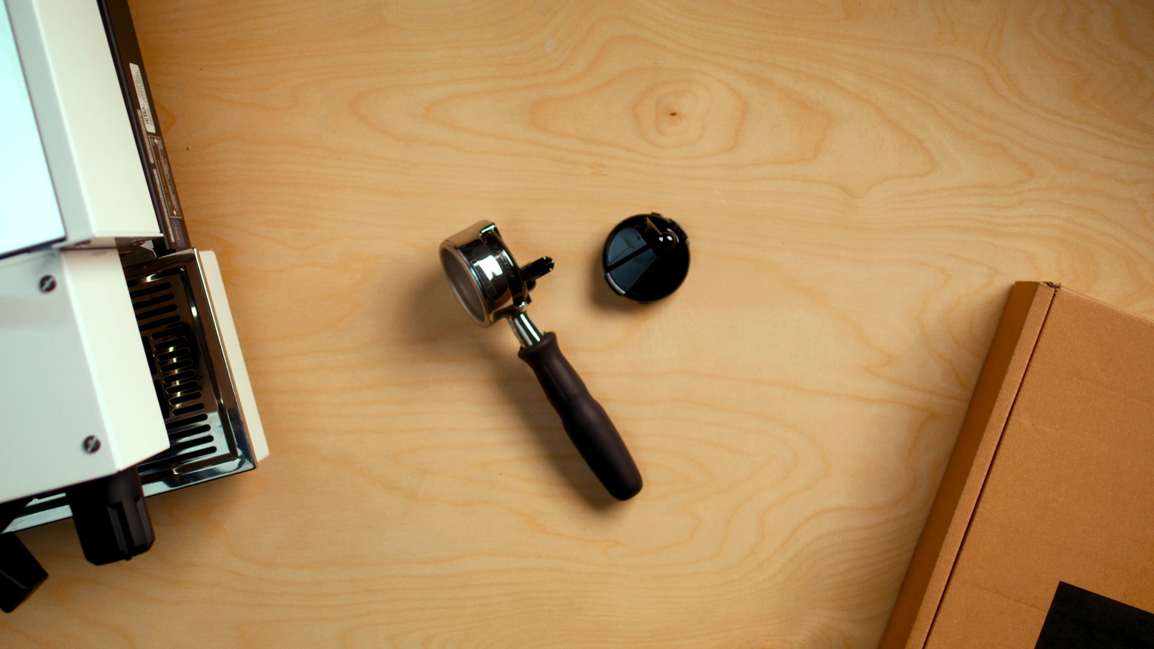 La Marzocco Linea Mini portafilter and tamper on wooden surface