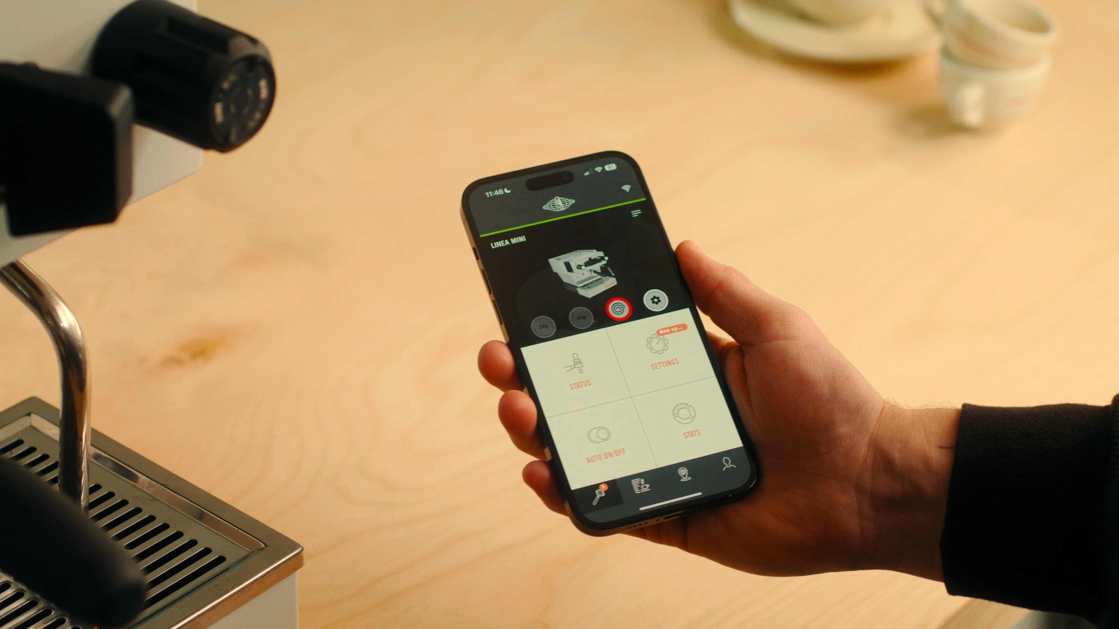 La Marzocco Linea Mini espresso machine with mobile app interface displaying brewing controls and menu options