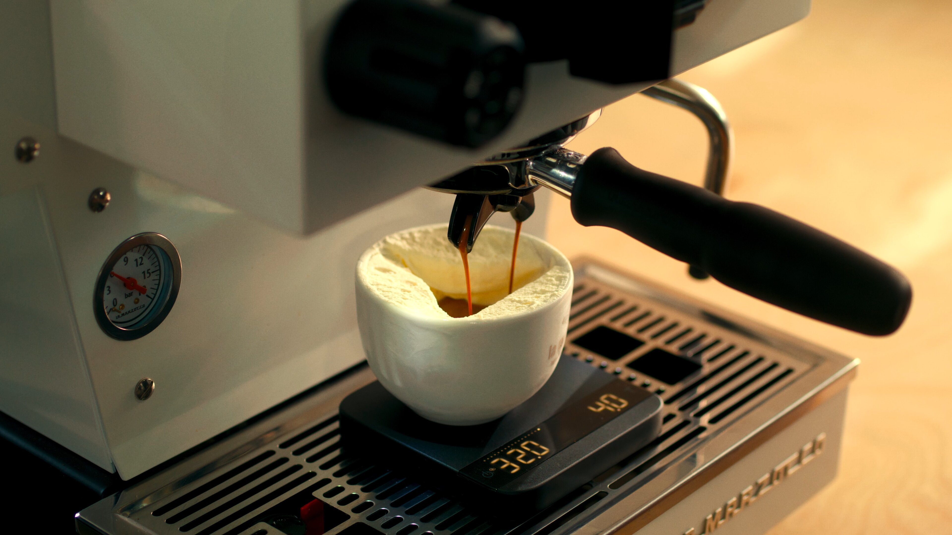 Pouring espresso from La Marzocco Linea Mini into a white cup, affogato preparation