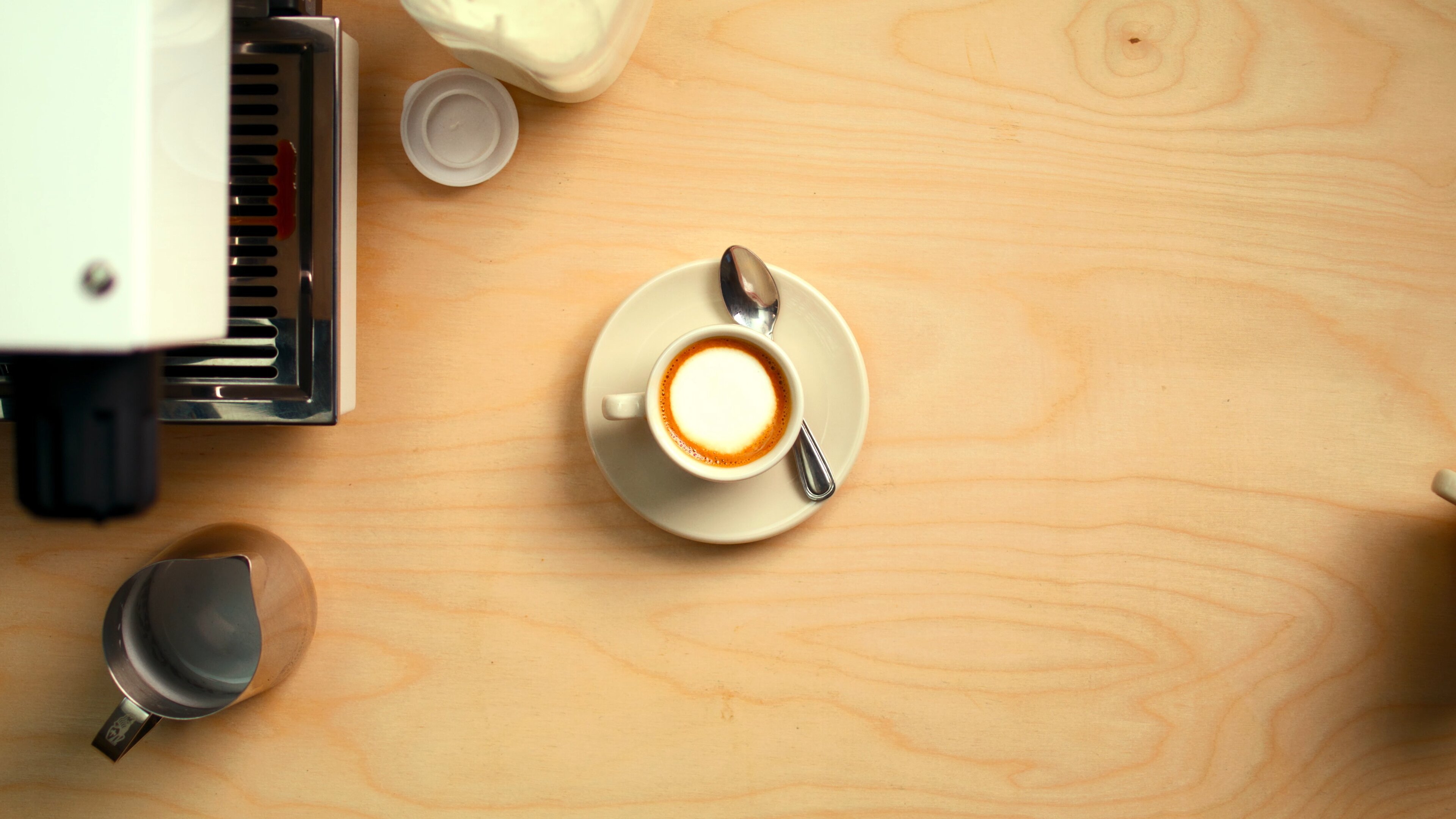 La Marzocco Linea Mini espresso machine with latte art in a home kitchen setting