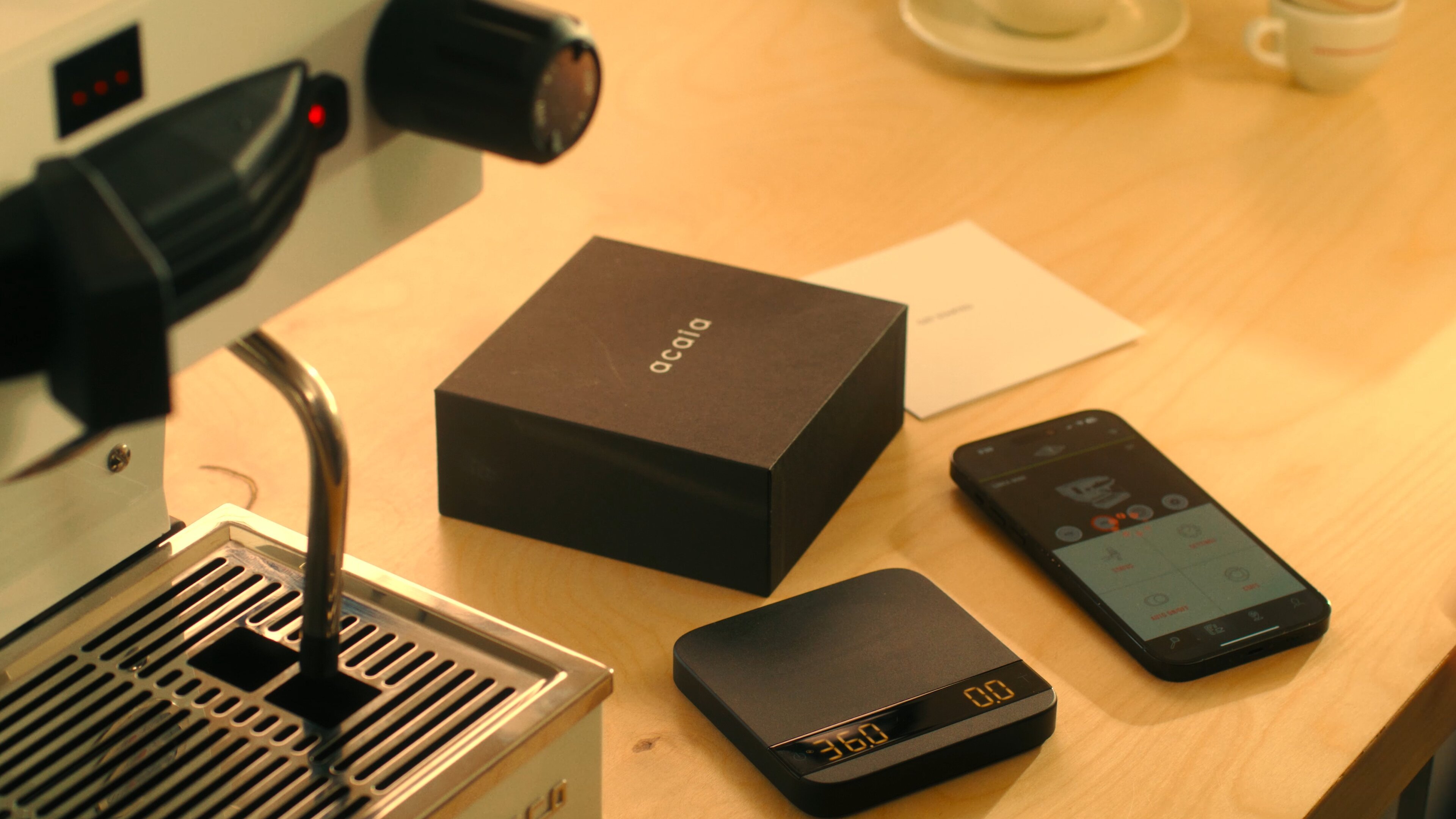 La Marzocco Linea Mini espresso machine with brew-by-weight setup and scale on wooden table