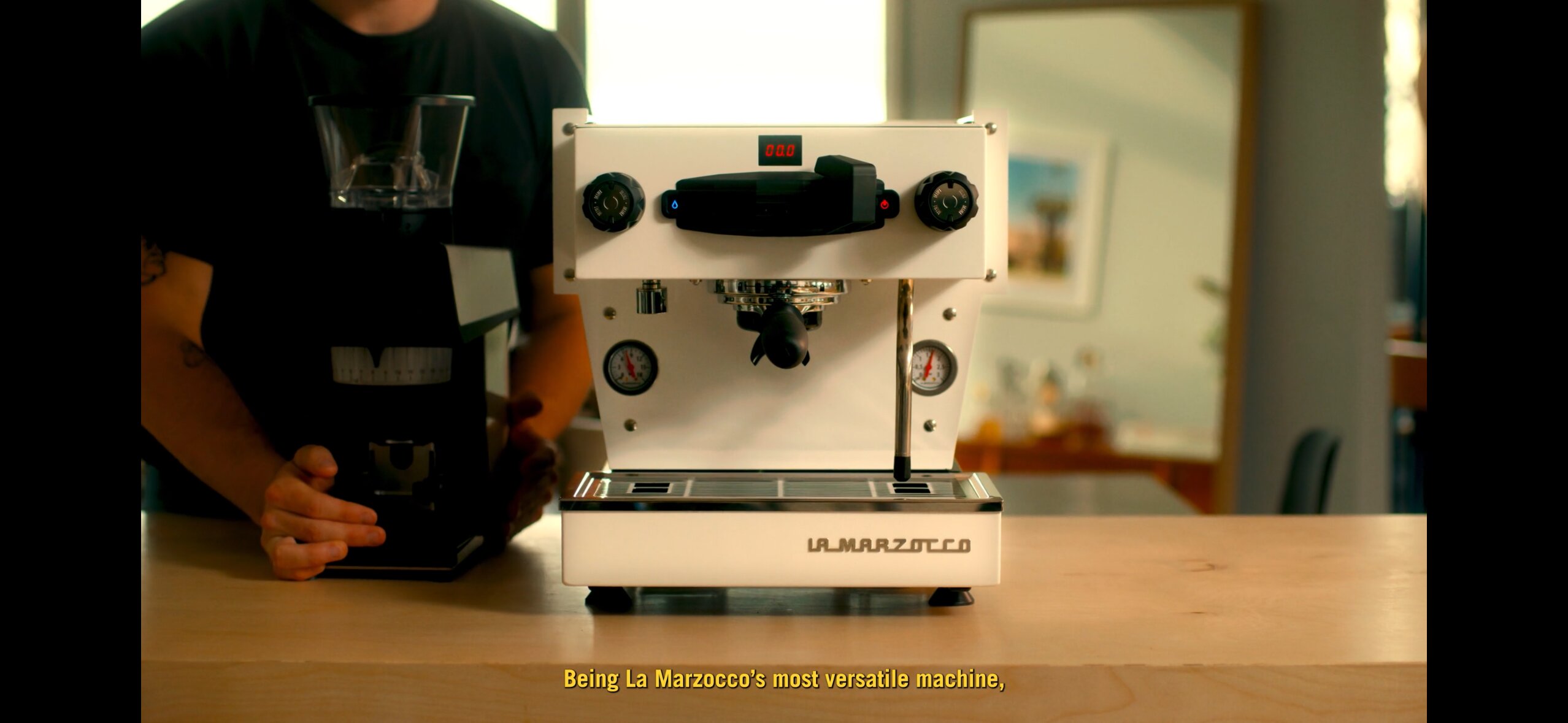 La Marzocco Linea Mini espresso machine in white, three-quarter front view with operator