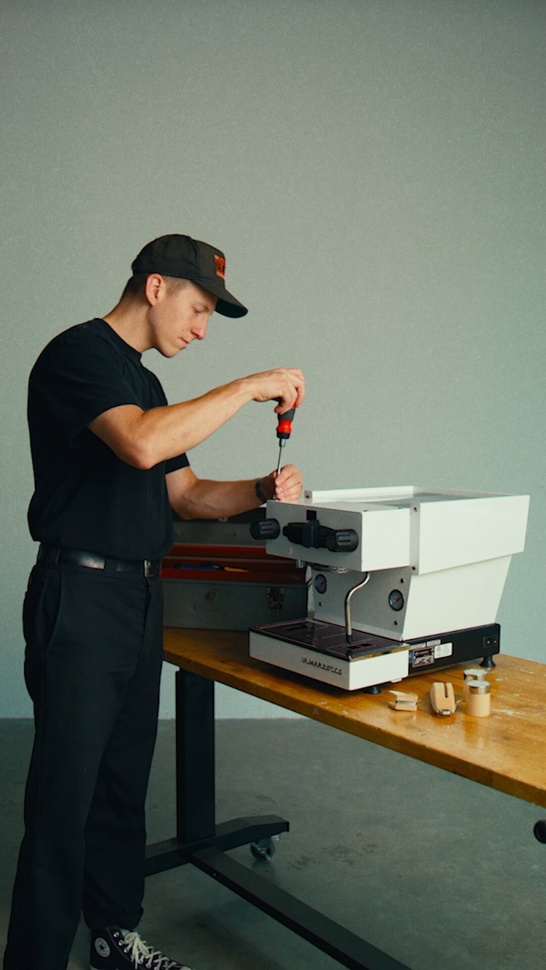 Technician installing a group head on a La Marzocco Linea Mini espresso machine