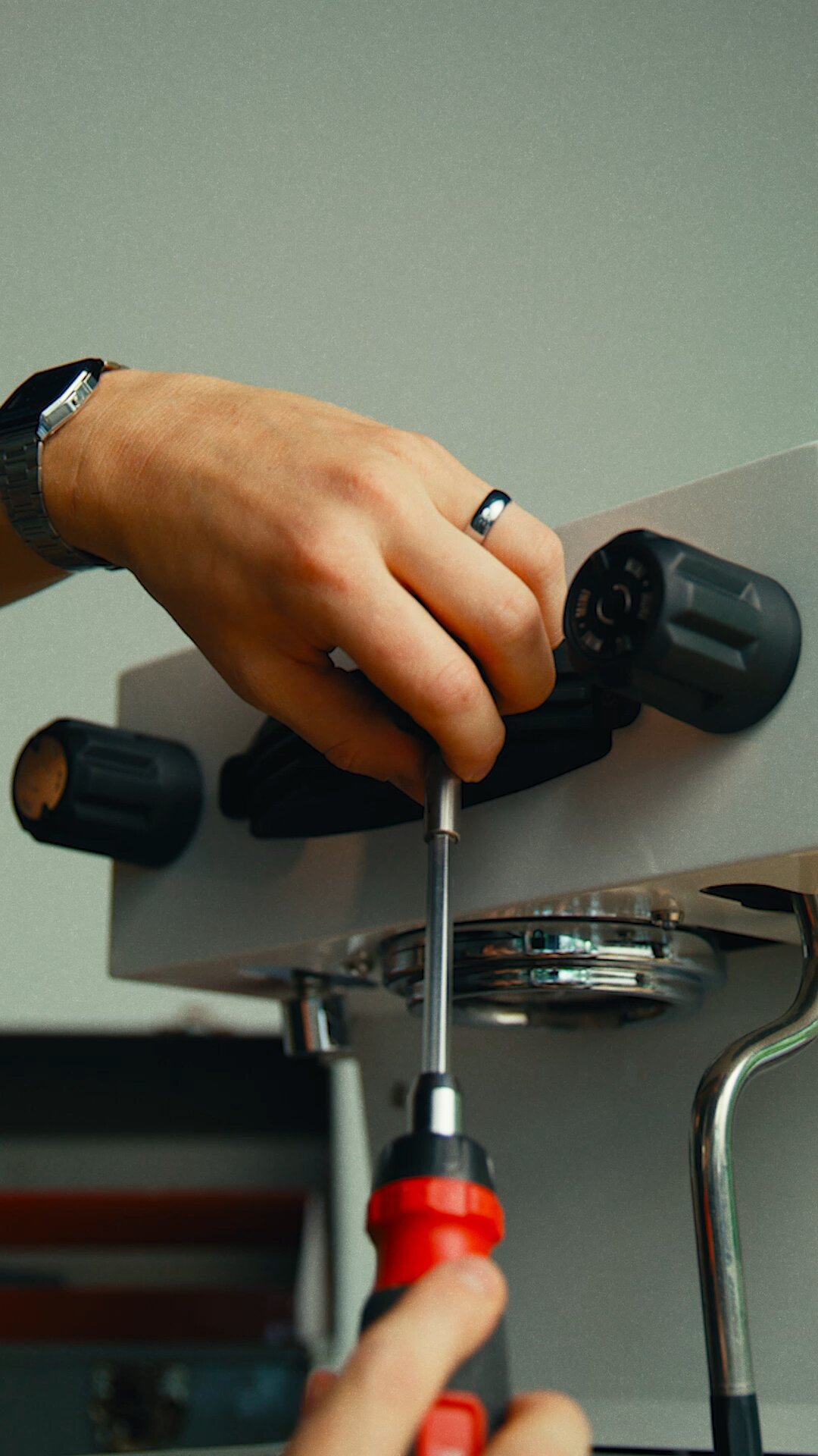 Hand adjusting the group head on a La Marzocco Linea Mini espresso machine
