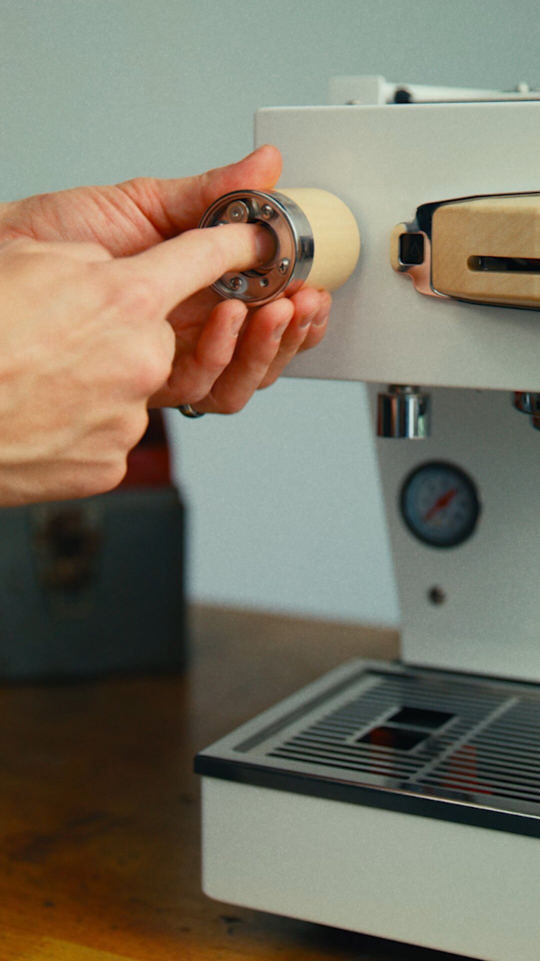 Hand inserting portafilter into La Marzocco Linea Mini espresso machine