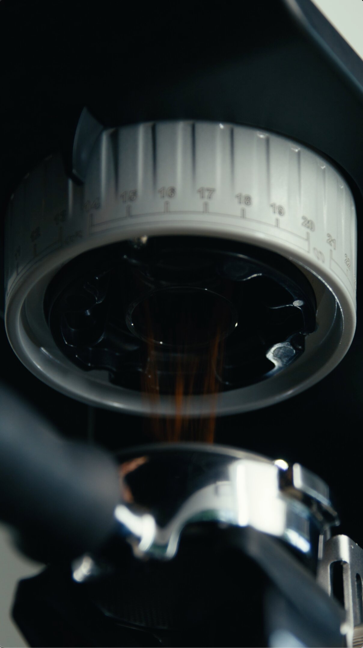 Close-up of espresso machine group head with pressure gauge and steam valve