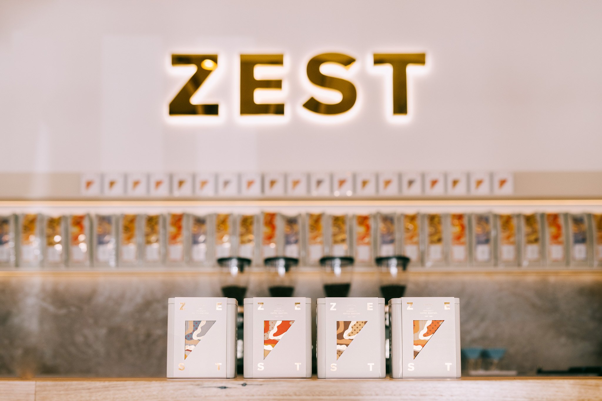 La Marzocco Zest grinder in white, front view with multiple color options displayed on shelf