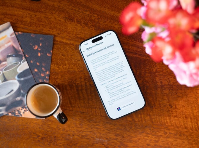 Espresso machine in home setting with coffee cup and flowers on wooden table
